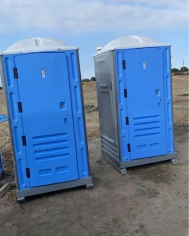 Blue and gray portable toilets outdoors