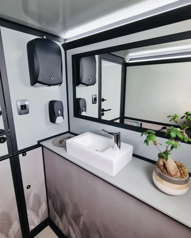 Restroom trailer interior with sinks and mirrors